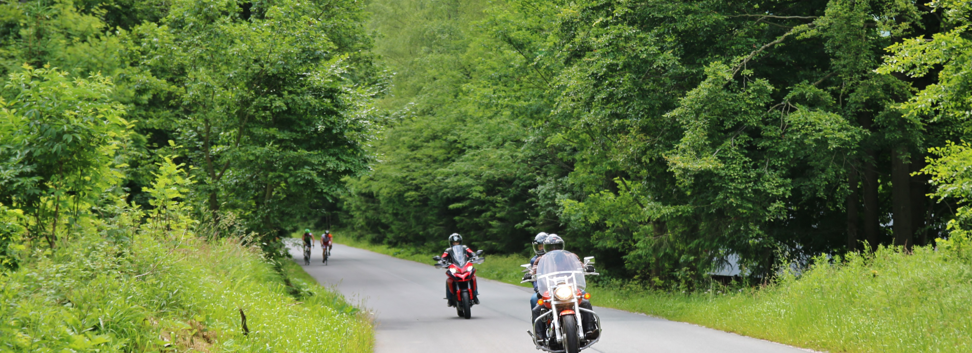 motorcycles and cyclists on a rural road