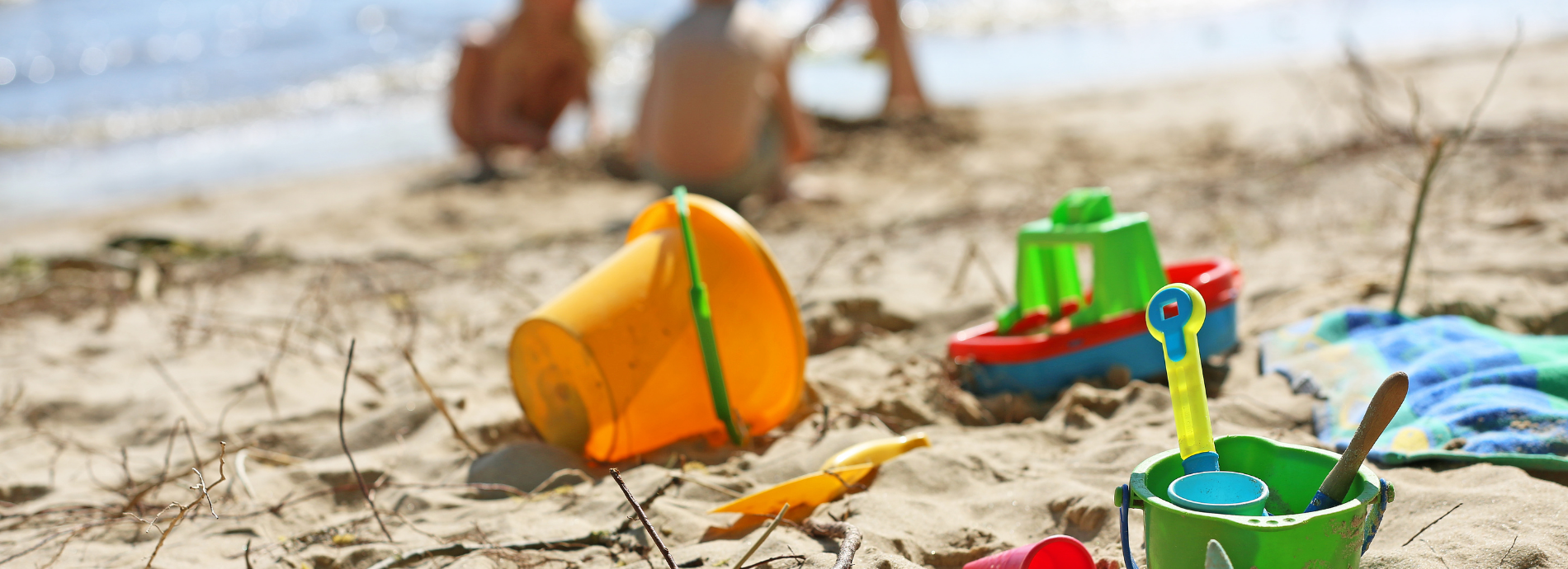 beach with sand buckets and children's toys