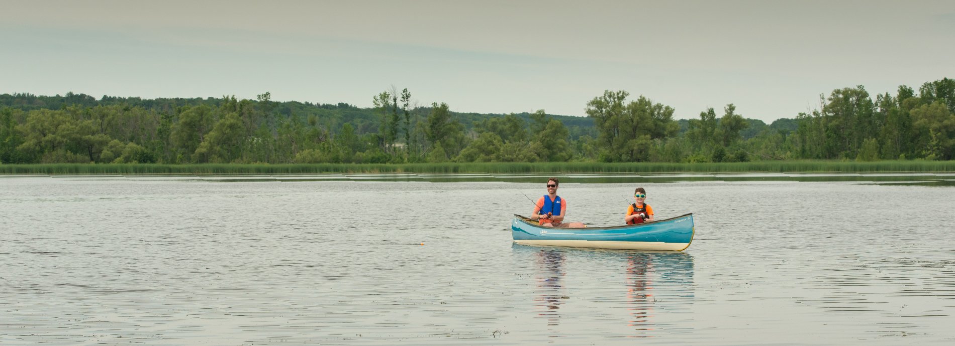 two people fishing from a canoe