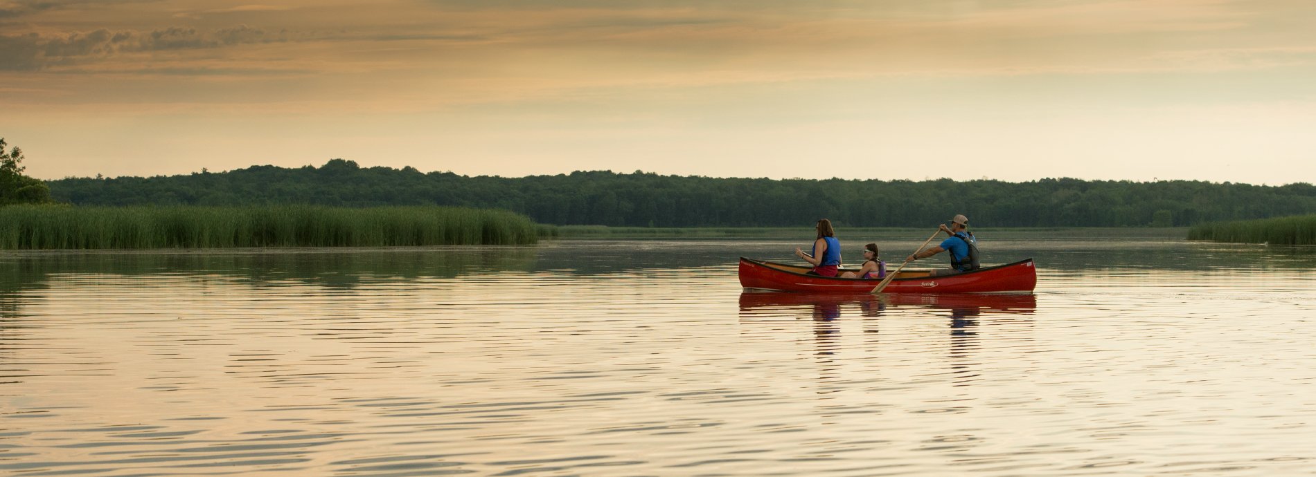 family canoeing at dusk
