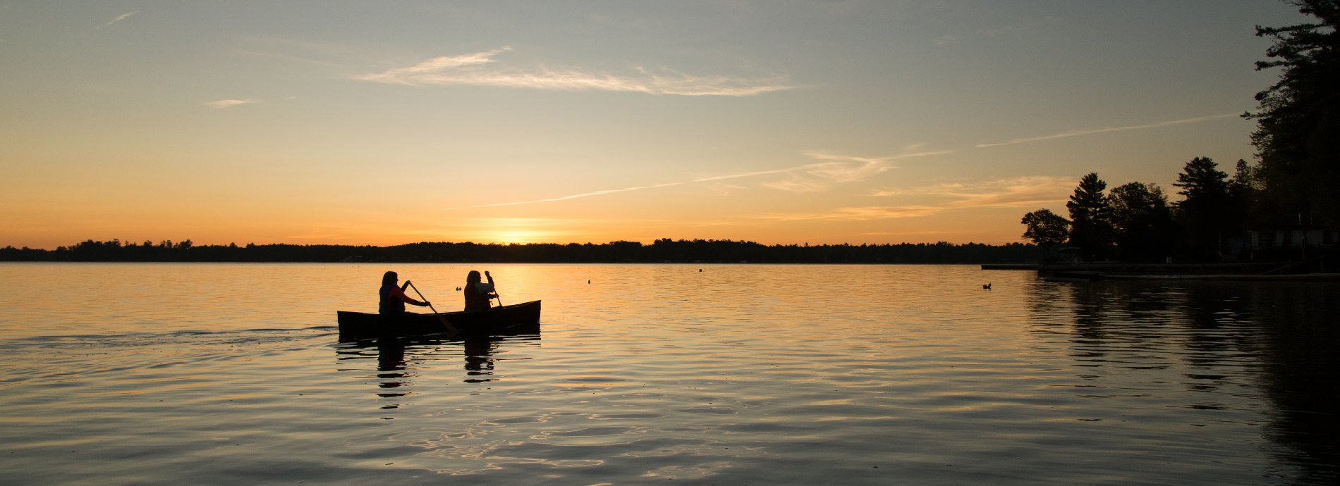 canoeing on a lake at sunset
