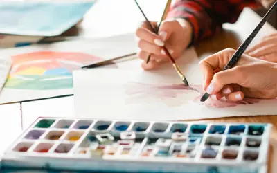 close up of hands and a watercolour palette